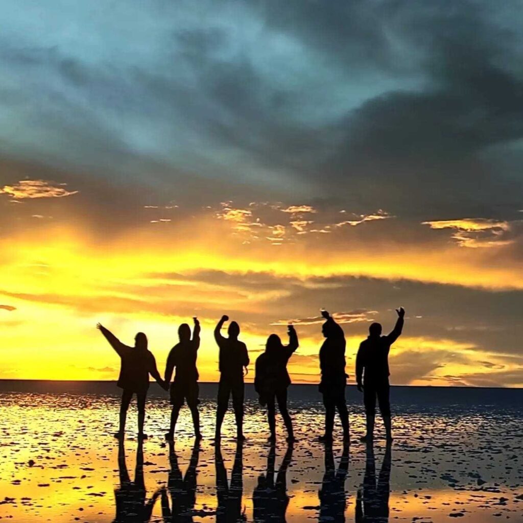 A group picture of the sunset in the salt flats in Bolivia